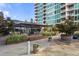 Condo's outdoor patio with lush landscaping and dining area, perfect for relaxing and entertaining at 943 Peachtree Ne St # 2009, Atlanta, GA 30309