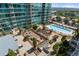 Aerial view of a condo's outdoor pool and lounge area, surrounded by lush greenery and city views at 943 Peachtree Ne St # 2009, Atlanta, GA 30309