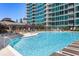 Condo swimming pool features sparkling blue water, lounge chairs, and views of the surrounding buildings at 943 Peachtree Ne St # 2009, Atlanta, GA 30309