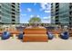 Inviting rooftop deck area with modern seating, tables, and beautiful city views in a condominium complex at 943 Peachtree Ne St # 2009, Atlanta, GA 30309