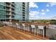 Stylish rooftop deck with a long bar table, white stools, and picturesque views of the surrounding greenery at 943 Peachtree Ne St # 2009, Atlanta, GA 30309
