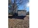 Backyard of a house featuring a wooden deck and trees that provide additional privacy and shade at 2520 Deerfield Nw Dr, Kennesaw, GA 30144