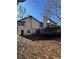 Backyard of a house featuring a chimney, door and windows to the outside, and a wooden deck at 2520 Deerfield Nw Dr, Kennesaw, GA 30144