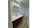 Bathroom featuring a vanity with modern fixtures, mirror, and lighting at 2520 Deerfield Nw Dr, Kennesaw, GA 30144