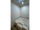 Bright bathroom with a large soaking tub and marble surround at 2520 Deerfield Nw Dr, Kennesaw, GA 30144
