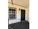 The entrance to a house with a black door, window, lamp, and a mat on a painted wooden porch at 2520 Deerfield Nw Dr, Kennesaw, GA 30144