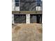 Two-car garage with dark doors and exterior lights, providing ample parking and curb appeal at 2520 Deerfield Nw Dr, Kennesaw, GA 30144