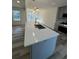 Bright kitchen island with quartz countertops, stainless steel sink, and modern lighting at 2520 Deerfield Nw Dr, Kennesaw, GA 30144