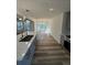 A kitchen with quartz island and view of breakfast area with modern lighting at 2520 Deerfield Nw Dr, Kennesaw, GA 30144