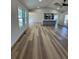 An open floor plan living room featuring hardwood floors, with a view into the kitchen and outdoor access at 2520 Deerfield Nw Dr, Kennesaw, GA 30144