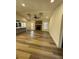 An open floor plan living room with a stone fireplace, vaulted ceiling, and hardwood floors at 2520 Deerfield Nw Dr, Kennesaw, GA 30144
