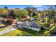 Wide aerial view of property, featuring the house, carport, shed, and surrounding trees at 409 Shannon Way, Lawrenceville, GA 30044