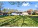 Spacious backyard with a wooden deck, partially covered patio and lush lawn at 409 Shannon Way, Lawrenceville, GA 30044