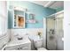 Well-lit bathroom featuring a glass-enclosed shower and tiled walls at 409 Shannon Way, Lawrenceville, GA 30044