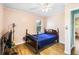 Bedroom featuring hardwood floors, a ceiling fan, and a small bed at 409 Shannon Way, Lawrenceville, GA 30044