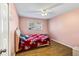 Cozy bedroom with hardwood floors and a ceiling fan, bathed in natural light at 409 Shannon Way, Lawrenceville, GA 30044