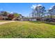 Charming one-story home with a lush green lawn and mature trees, showcasing its curb appeal at 409 Shannon Way, Lawrenceville, GA 30044