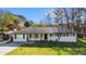 Charming ranch-style home with a well-manicured lawn and lush landscaping at 409 Shannon Way, Lawrenceville, GA 30044