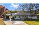 Picture of a well-kept ranch-style home with a long driveway and carport at 409 Shannon Way, Lawrenceville, GA 30044