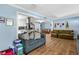 Spacious living room with hardwood floors and comfortable couches next to the kitchen and dining area at 409 Shannon Way, Lawrenceville, GA 30044