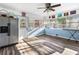 Bright sunroom featuring wood floor, many windows, and a ceiling fan, bringing the outside in at 409 Shannon Way, Lawrenceville, GA 30044