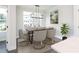 A dining room featuring a modern light fixture, a wood table, and a large window with a street view at 345 Skylar Se Way, Atlanta, GA 30315