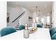 Elegant dining room featuring a white marble table with blue chairs and decorative glassware at 345 Skylar Se Way, Atlanta, GA 30315