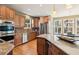 Open kitchen features stainless appliances, an island, and a breakfast nook at 4543 Fairecroft Ter, Suwanee, GA 30024