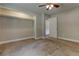 This cozy bedroom offers ample closet space, neutral paint, a ceiling fan, and plush carpeting at 612 Rich Davis Rd, Hiram, GA 30141