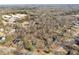 This neighborhood aerial view shows houses surrounded by many trees near a large school building at 6198 Rocky Creek Dr, Douglasville, GA 30135