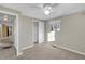 Neutral bedroom with carpet, view to a closet, and a window with a view of the outside at 6198 Rocky Creek Dr, Douglasville, GA 30135