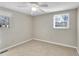 Neutral bedroom with carpet, white trim, two windows, and a white ceiling fan at 6198 Rocky Creek Dr, Douglasville, GA 30135
