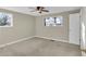 Neutral bedroom with carpet, two windows, and a dark-colored ceiling fan at 6198 Rocky Creek Dr, Douglasville, GA 30135