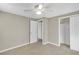 Bedroom with carpet, white trim, a closet, and view into another room at 6198 Rocky Creek Dr, Douglasville, GA 30135