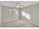 Neutral bedroom with carpet, white trim, and a ceiling fan with colorful blades at 6198 Rocky Creek Dr, Douglasville, GA 30135