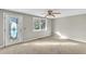 Bedroom featuring neutral paint, carpet floors, a ceiling fan, and a large glass paneled door and window at 6198 Rocky Creek Dr, Douglasville, GA 30135