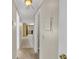 Hallway leading to the kitchen, featuring tile flooring and a view of the kitchen cabinets at 6198 Rocky Creek Dr, Douglasville, GA 30135