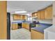 A well-lit kitchen features tile floors, stainless steel appliances, and wooden cabinets with ample counter space at 6198 Rocky Creek Dr, Douglasville, GA 30135