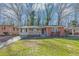 Charming single-story home featuring a brick facade, front porch, and well-maintained lawn, blending classic charm with modern comfort at 2084 Snow Sw Rd, Atlanta, GA 30311