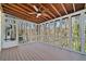 A view of the upper screened porch with a wooden ceiling and ceiling fan at 2938 Thornridge Dr, Atlanta, GA 30340