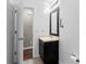 Clean bathroom with single vanity, large mirror, and neutral tile floor at 5336 Monticello Dr, Villa Rica, GA 30180