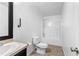 Clean bathroom featuring a shower/tub combo, neutral tile floor, and modern fixtures at 5336 Monticello Dr, Villa Rica, GA 30180