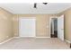 Bedroom featuring neutral carpet, a ceiling fan, and a large closet at 5336 Monticello Dr, Villa Rica, GA 30180