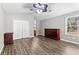 Bedroom featuring wood floors, ceiling fan, dresser, and a double-door closet at 5336 Monticello Dr, Villa Rica, GA 30180