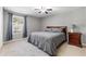 Bedroom featuring a large bed, neutral walls, carpet, and a window overlooking the yard at 5336 Monticello Dr, Villa Rica, GA 30180