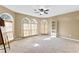 Inviting living room featuring arched windows, neutral carpet, and a built in bookcase at 5336 Monticello Dr, Villa Rica, GA 30180