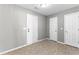 Mud room features neutral walls, tile floors, and three white doors at 5336 Monticello Dr, Villa Rica, GA 30180