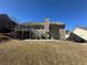 Spacious backyard with a two-story home, a raised deck, and a stairwell leading to ground-level patio at 903 Creek Bottom Rd, Loganville, GA 30052