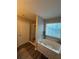 Soaking tub in primary bathroom features a window view and a separate shower at 903 Creek Bottom Rd, Loganville, GA 30052