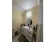 Bathroom featuring vanity, round mirror, under cabinet storage, and modern lighting fixture at 903 Creek Bottom Rd, Loganville, GA 30052